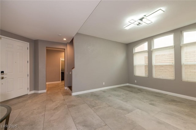 empty room with baseboards and recessed lighting