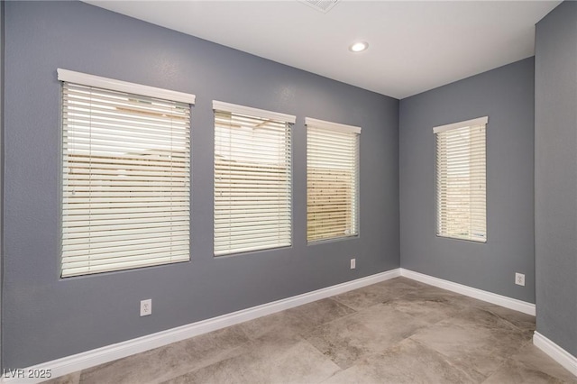 spare room with baseboards and recessed lighting