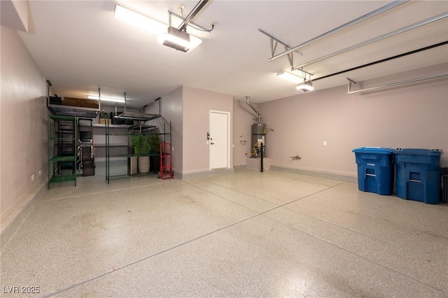 garage featuring a garage door opener, secured water heater, and baseboards