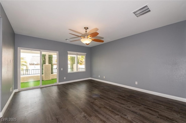 unfurnished room featuring dark wood-style floors and baseboards