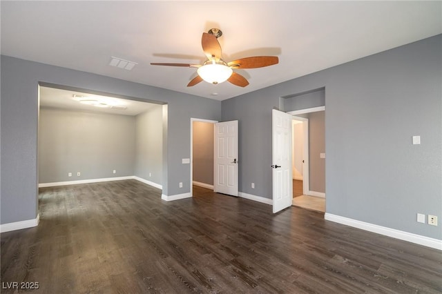 unfurnished room featuring ceiling fan, dark wood-style flooring, and baseboards
