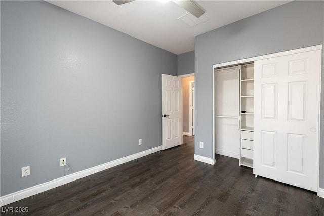 unfurnished bedroom featuring dark wood-type flooring, baseboards, and a closet