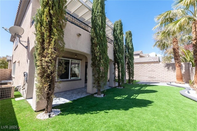 view of yard featuring central AC unit and a patio