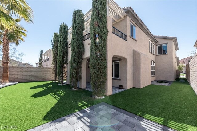 view of side of property with stucco siding and a patio
