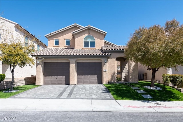 mediterranean / spanish home featuring stucco siding, a garage, decorative driveway, and a tile roof