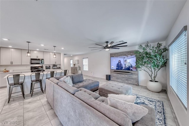 living area with recessed lighting, a ceiling fan, and light tile patterned flooring