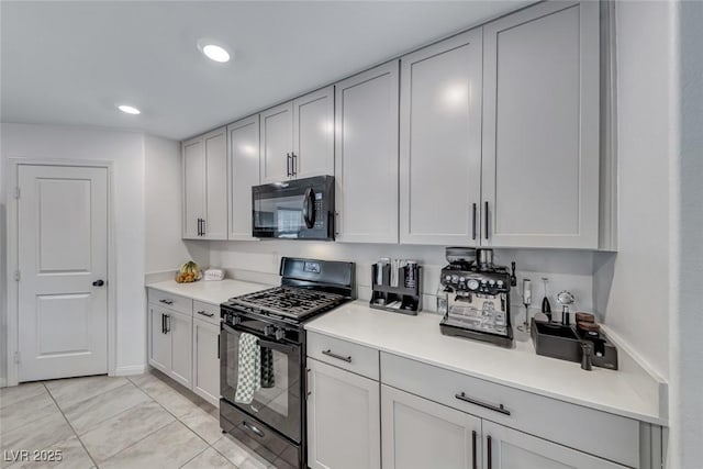 kitchen with black appliances, light countertops, and recessed lighting