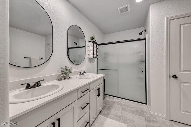 full bathroom featuring a stall shower and double vanity