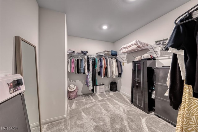 spacious closet with carpet flooring