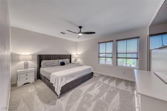 carpeted bedroom with multiple windows, baseboards, and a ceiling fan
