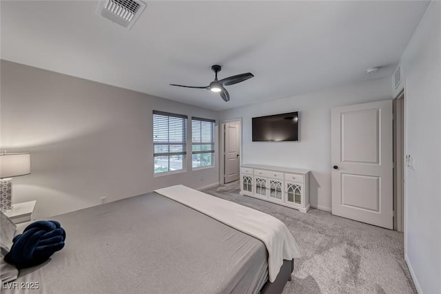 carpeted bedroom featuring baseboards and a ceiling fan