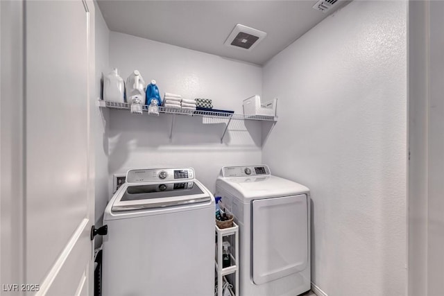 laundry room featuring washing machine and clothes dryer