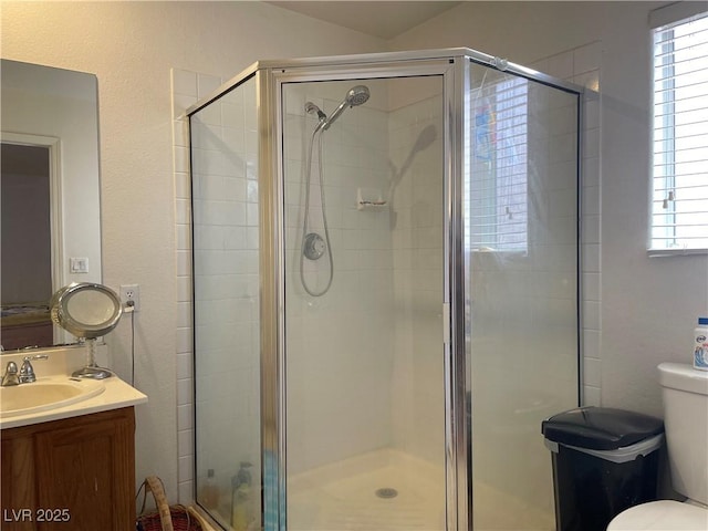 bathroom featuring a stall shower and toilet