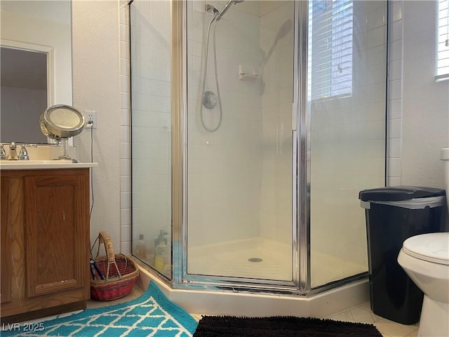 bathroom featuring a shower stall, vanity, and toilet