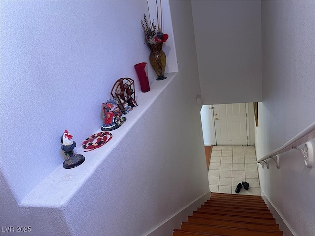 staircase with tile patterned floors and baseboards