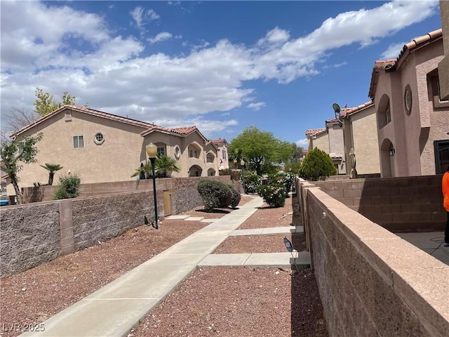 surrounding community with fence and a residential view