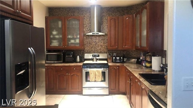 3301 W Colton Ave, North Las Vegas, NV 89032 - kitchen with appliances with stainless steel finishes, wall chimney range hood, backsplash, and light tile patterned floors