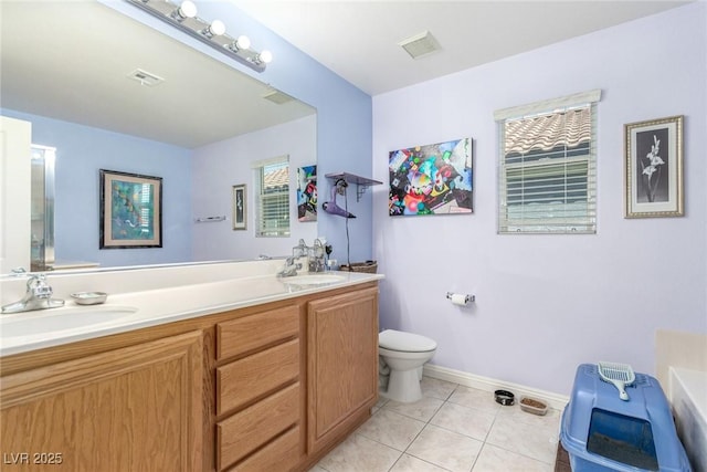 11739 Village Arbor St, Las Vegas, NV 89183 - bathroom featuring tile patterned floors, toilet, double vanity, baseboards, and a bath