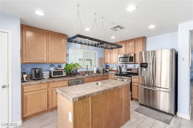 11739 Village Arbor St, Las Vegas, NV 89183 - kitchen with appliances with stainless steel finishes, a sink, a center island, recessed lighting, and light brown cabinetry