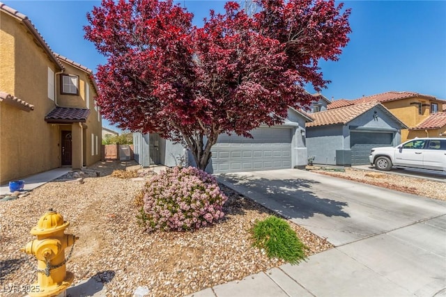 11739 Village Arbor St, Las Vegas, NV 89183 - view of front of property featuring concrete driveway, stucco siding, and a tile roof