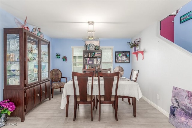 11739 Village Arbor St, Las Vegas, NV 89183 - dining room featuring light wood-type flooring and baseboards