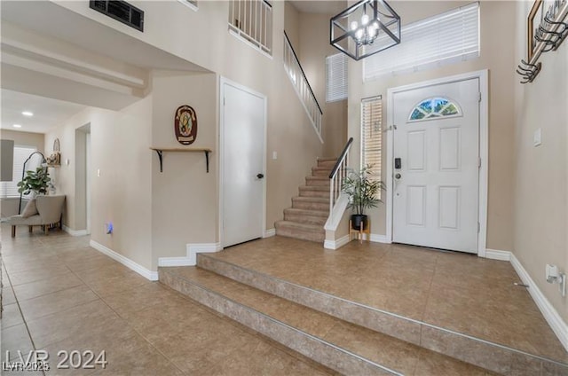 4209 Glass Lantern Dr, North Las Vegas, NV 89032 - tiled entryway with stairs, baseboards, a chandelier, recessed lighting, and a high ceiling