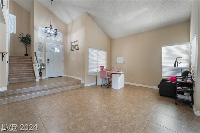 4209 Glass Lantern Dr, North Las Vegas, NV 89032 - foyer with a chandelier, tile patterned floors, healthy amount of natural light, high vaulted ceiling, and baseboards