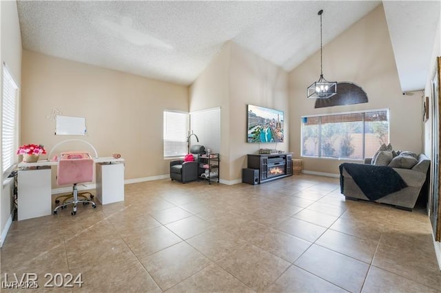 4209 Glass Lantern Dr, North Las Vegas, NV 89032 - living room featuring healthy amount of natural light, tile patterned flooring, high vaulted ceiling, a textured ceiling, and baseboards