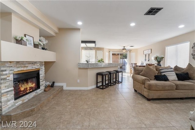 4209 Glass Lantern Dr, North Las Vegas, NV 89032 - living room with light tile patterned floors, a ceiling fan, recessed lighting, a stone fireplace, and baseboards