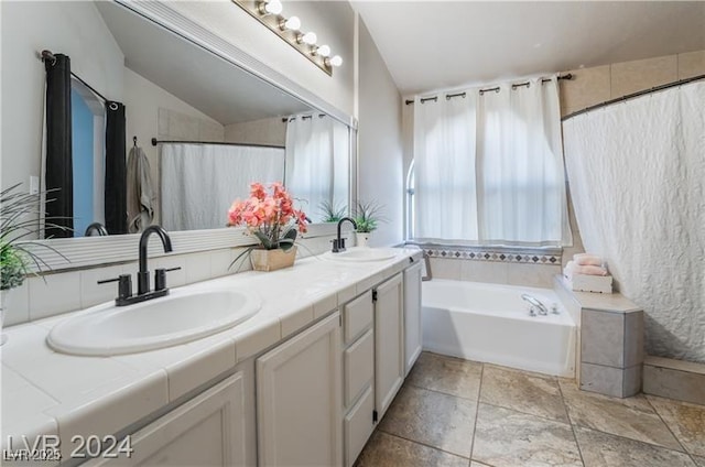 4209 Glass Lantern Dr, North Las Vegas, NV 89032 - full bath featuring double vanity, a garden tub, and stone finish floors