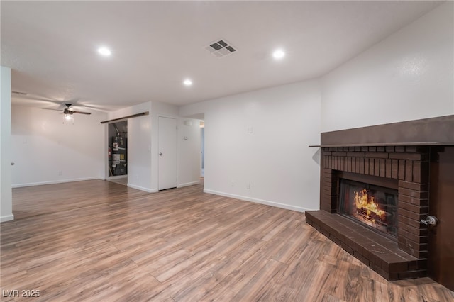 6711 W Charleston Blvd Unit 2, Las Vegas, NV 89146 - unfurnished living room with a fireplace, wood finished floors, recessed lighting, baseboards, and a ceiling fan