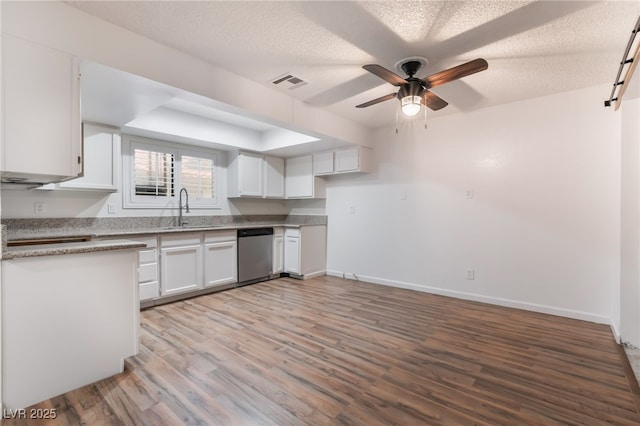6711 W Charleston Blvd Unit 2, Las Vegas, NV 89146 - kitchen with stainless steel dishwasher, a sink, ceiling fan, white cabinetry, and light wood-style floors