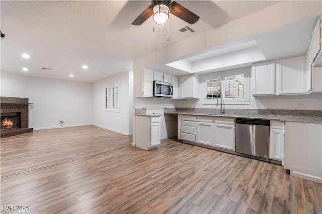6711 W Charleston Blvd Unit 2, Las Vegas, NV 89146 - kitchen with appliances with stainless steel finishes, a sink, open floor plan, ceiling fan, and light wood-type flooring