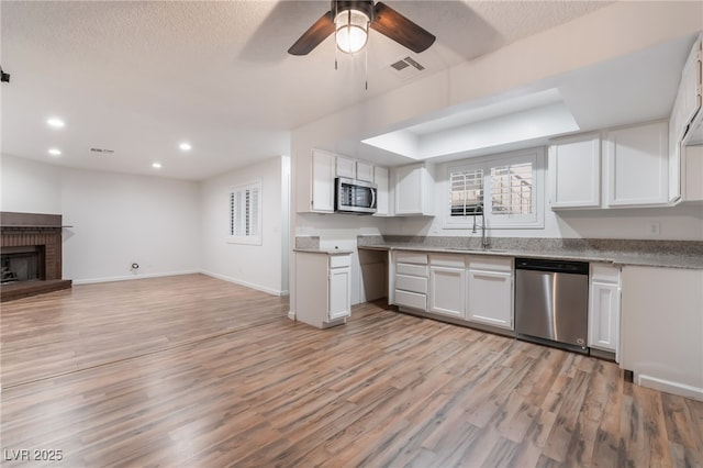 6711 W Charleston Blvd Unit 2, Las Vegas, NV 89146 - kitchen with appliances with stainless steel finishes, open floor plan, a ceiling fan, white cabinets, and recessed lighting