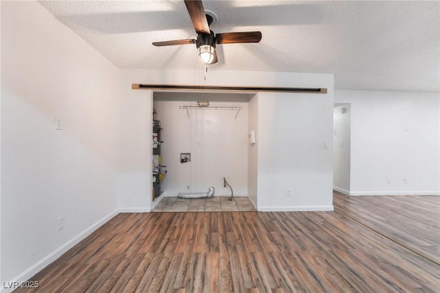 6711 W Charleston Blvd Unit 2, Las Vegas, NV 89146 - empty room with wood finished floors, a ceiling fan, baseboards, a textured ceiling, and secured water heater