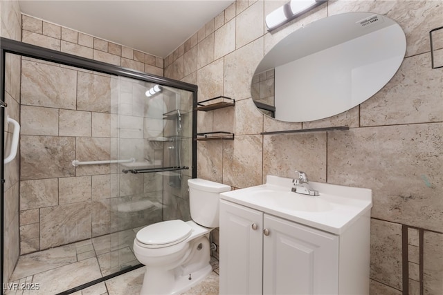6711 W Charleston Blvd Unit 2, Las Vegas, NV 89146 - full bathroom with tile walls, a stall shower, toilet, and vanity