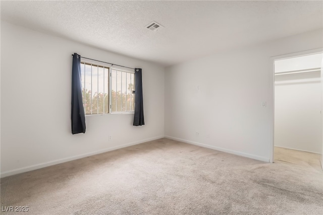 6711 W Charleston Blvd Unit 2, Las Vegas, NV 89146 - unfurnished room featuring carpet, baseboards, and a textured ceiling