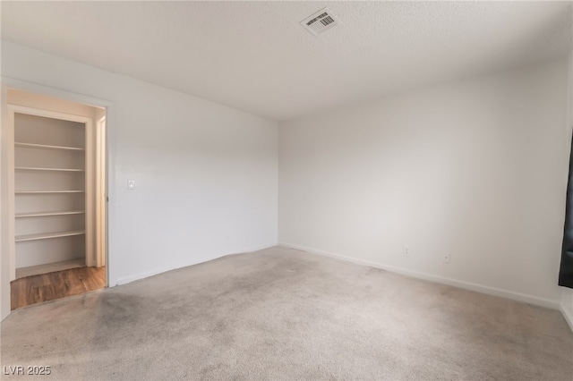 6711 W Charleston Blvd Unit 2, Las Vegas, NV 89146 - unfurnished bedroom featuring carpet floors, a walk in closet, and baseboards