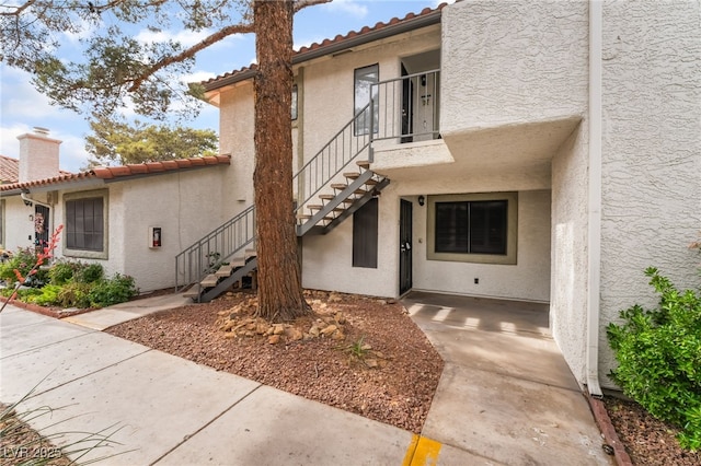 6711 W Charleston Blvd Unit 2, Las Vegas, NV 89146 - view of exterior entry featuring a tiled roof and stucco siding