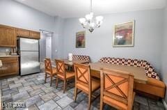1012 Greystone Dr, Las Vegas, NV 89108 - dining room with a chandelier, stone finish floors, and breakfast area
