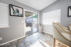 1012 Greystone Dr, Las Vegas, NV 89108 - entryway featuring lofted ceiling, baseboards, and stone finish flooring