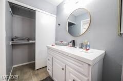 1012 Greystone Dr, Las Vegas, NV 89108 - bathroom featuring wood finished floors, baseboards, and vanity