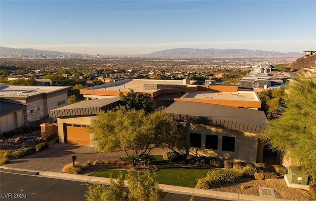 view of front of house with a mountain view, a residential view, and driveway