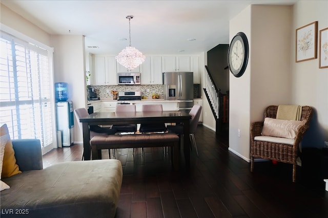 7257 Early Pioneer Ave, Las Vegas, NV 89129 - dining room featuring dark wood finished floors, stairway, baseboards, and a chandelier