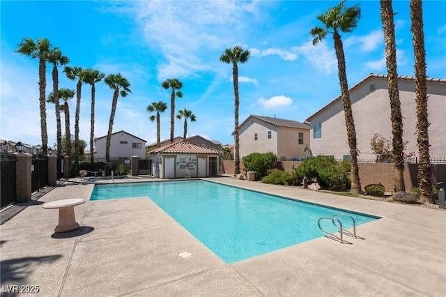 7257 Early Pioneer Ave, Las Vegas, NV 89129 - community pool featuring a patio and an outbuilding