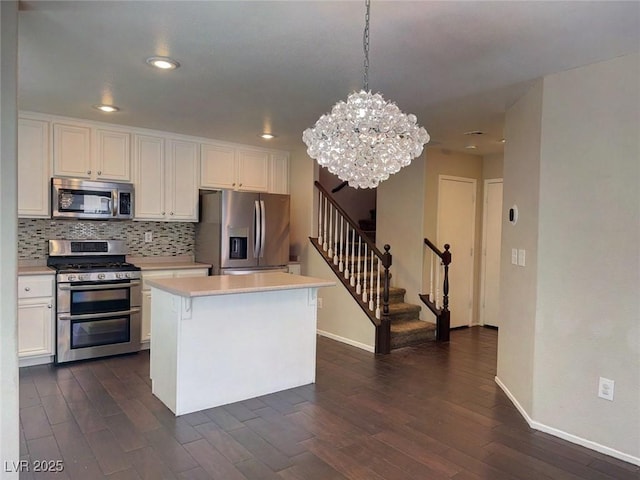 7257 Early Pioneer Ave, Las Vegas, NV 89129 - kitchen featuring stainless steel appliances, baseboards, dark wood finished floors, and recessed lighting