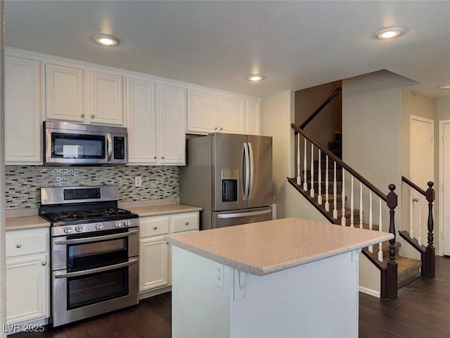 7257 Early Pioneer Ave, Las Vegas, NV 89129 - kitchen featuring appliances with stainless steel finishes, dark wood-style flooring, white cabinets, and recessed lighting
