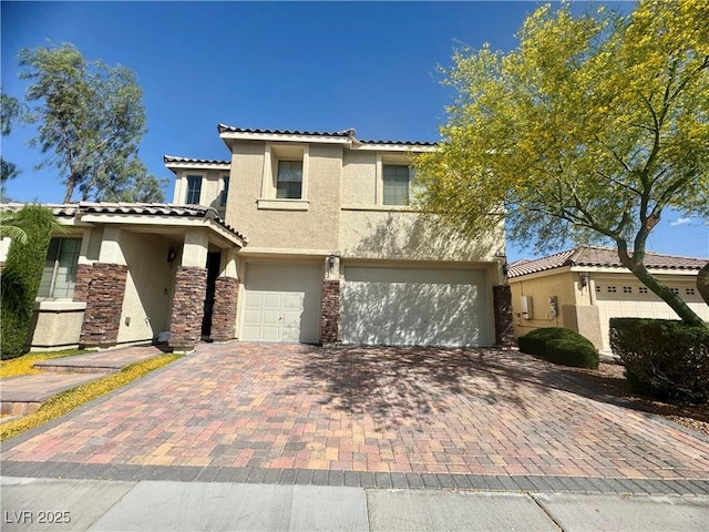640 House Blend Ln, Henderson, NV 89052 - view of front facade featuring stucco siding, an attached garage, decorative driveway, and a tile roof