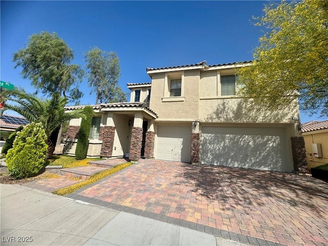 640 House Blend Ln, Henderson, NV 89052 - view of front of property with stucco siding, a tile roof, an attached garage, decorative driveway, and stone siding
