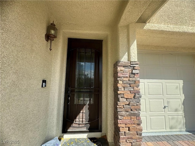 640 House Blend Ln, Henderson, NV 89052 - property entrance featuring stucco siding, a garage, and stone siding